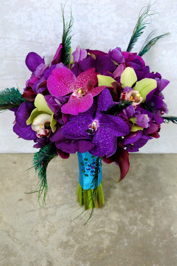 the bridal bouquet was peacock feather themed as was her event and even 