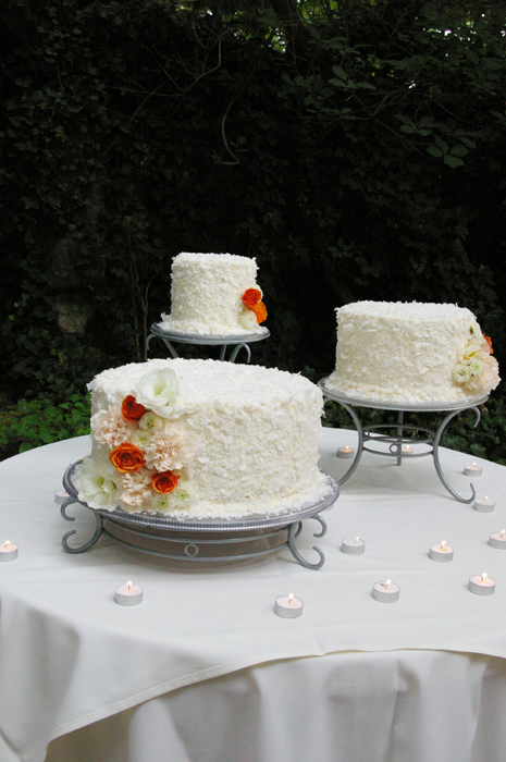 fresh flowers on coconut wedding cake orange cream studio stems
